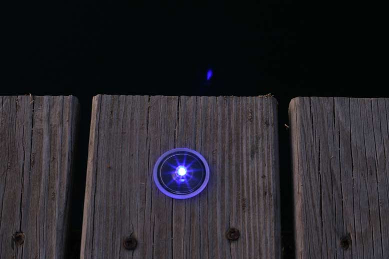 Picture of small solar dock dot light installed.