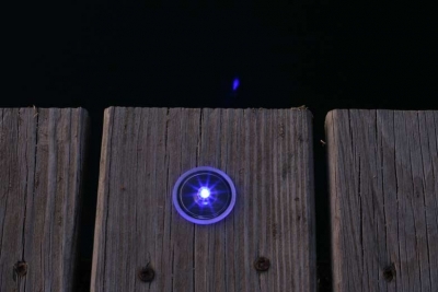 Picture of small solar dock dot light installed.